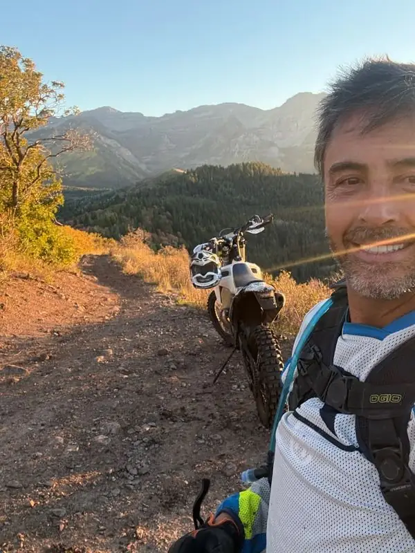 Dirt bike trail selfie, sunset mountain backdrop