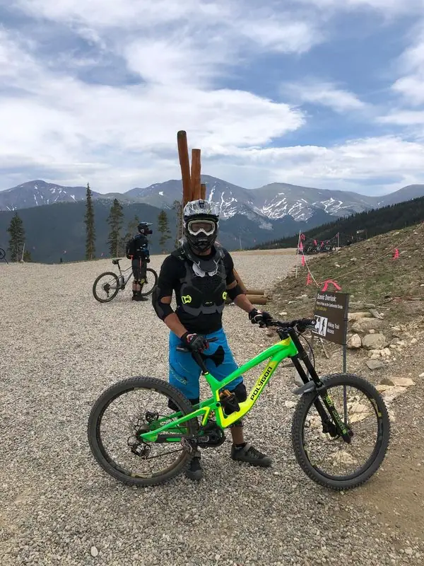 Full-armor downhill mountain biker at scenic overlook