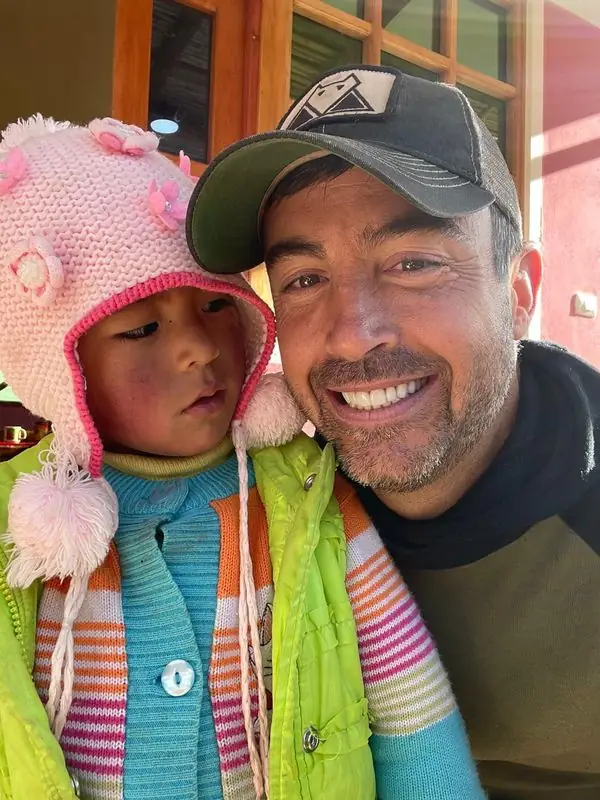 Smiling selfie with young child in pink knit hat