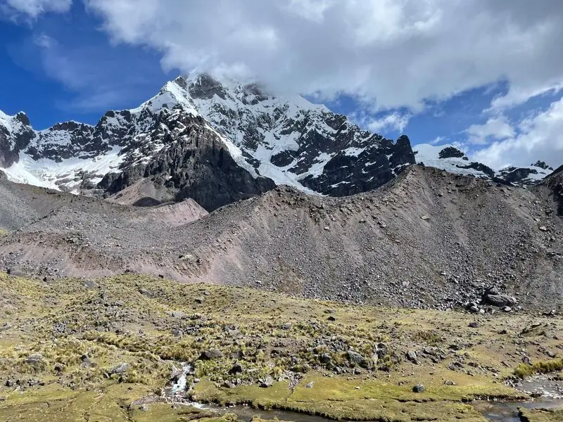 Snow-capped Andean peak over alpine valley, no people