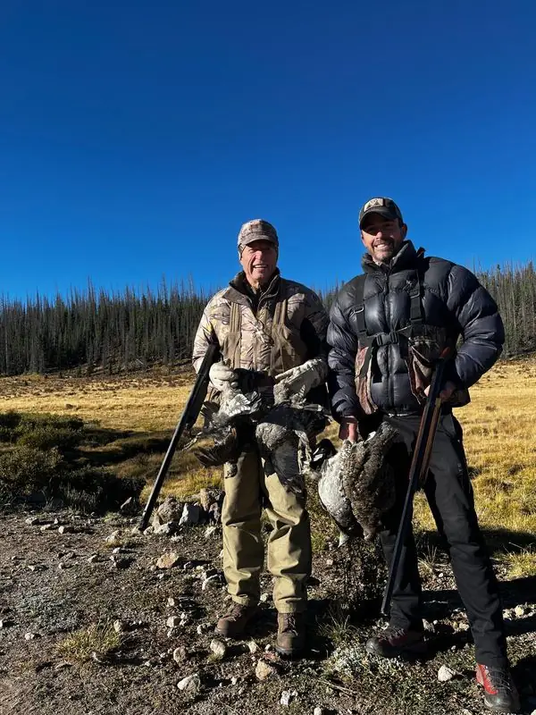 Grouse hunting with older companion, shotguns and birds