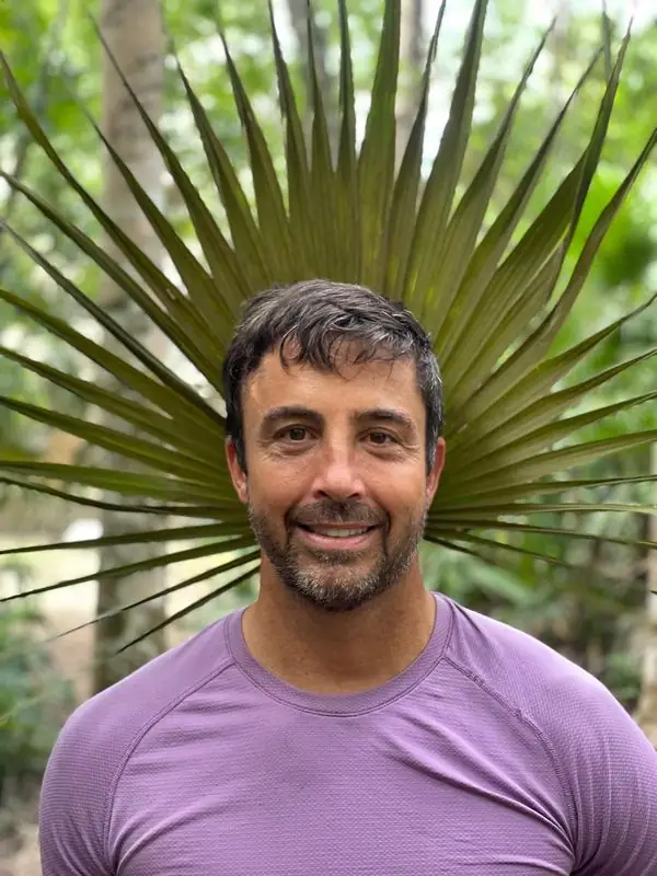 Smiling headshot with fan palm frond halo backdrop