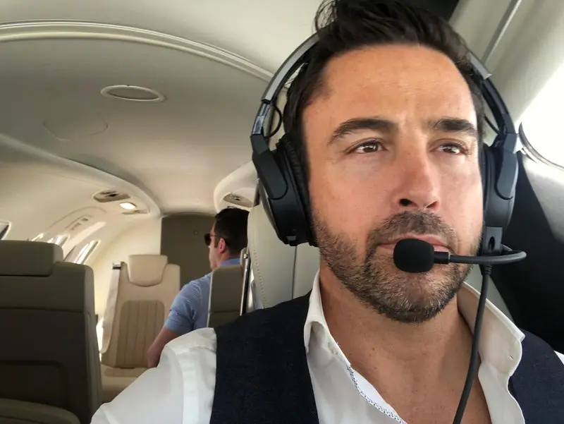 Aviation headset selfie inside private jet cabin