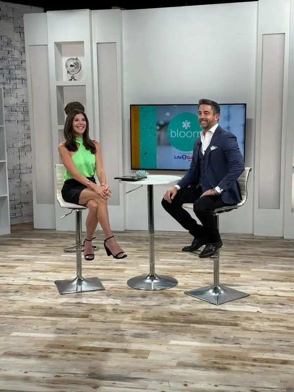 Travis interviewed on TV studio set with host